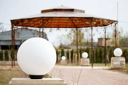 several round lamps and a wrought iron gazebo on the territory of the registry office for the marriage ceremony.の写真素材