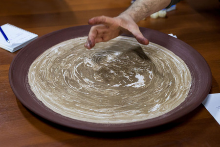 meeting potters. training courses for novice ceramists. reportage. A large plate in the style of Nerikomi - several types of clays. made on plaster formの写真素材