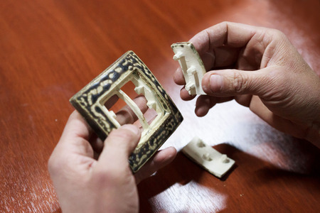 the master potter with 15 years of experience shows a ceramic switch made with a plaster mold. double firing, icing. Ceramist meeting and exchange of experience. reportageの写真素材