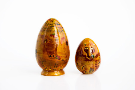 Russian varnished dolls babushkas or matryoshkas painted by a child. horse, in the form of an egg, inside of which is an egg foal. on a white backgroundの写真素材