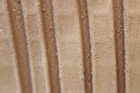 side wall of a red clay pot with vertical stripes made for decoration and texture. dried and unburned product. macroの写真素材