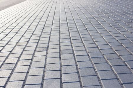professionally laid paving slabs on a large stretch of urban territory, beautifully shining under the light of the setting evening sun.の写真素材