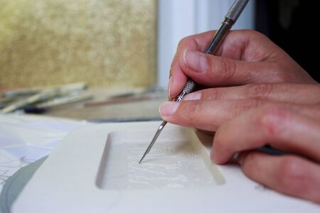 making a plaster mold for pouring liquid clay and creating a tablet with Egyptian hieroglyphs meaning Cat.の写真素材