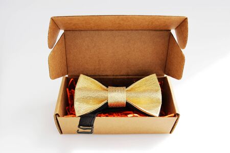 bow tie in a cardboard gift box. color gold.の写真素材