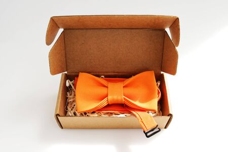 bow tie in a cardboard gift box. color orangeの写真素材