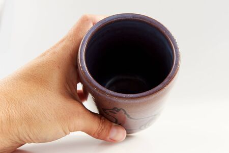 small vase with an Egyptian cat made of red clay covered with transparent glaze. Ancient Egyptian hieroglyph. the glaze turned violet due to excess firing temperature.の写真素材