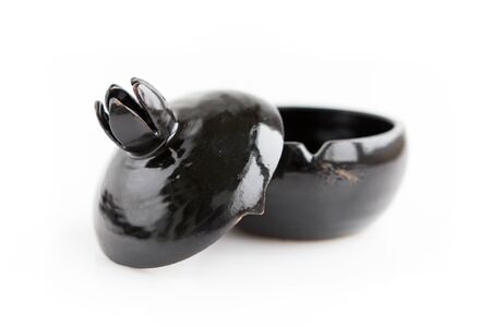 black clay pomegranate on a white background. original casket with a cover in the form of a pomegranate.の写真素材