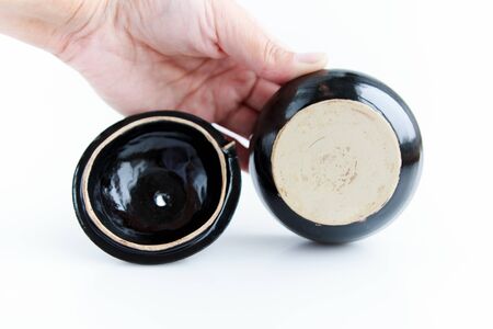 black clay pomegranate on a white background. original casket with a cover in the form of a pomegranate.の写真素材