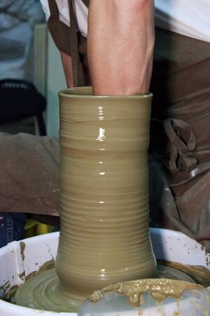 experienced potter makes a large vase on a potter's wheel. clay product. hands of a potter. reportage shootingの写真素材