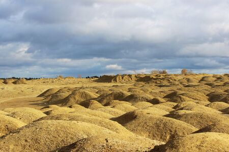 artificial mountains of crushed stone and sand at a quarry for the extraction of building limestoneの写真素材