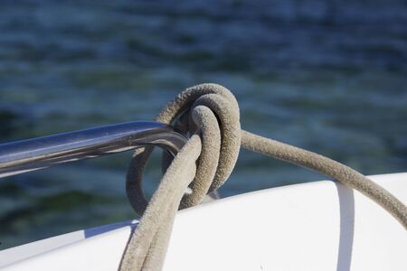 mooring rope tied by a sea knot on the railing of the boat. reportage shootingの写真素材
