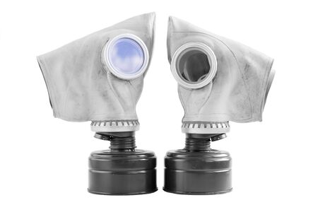 two old soviet gas masks on a white background. concept of peace and war. a means of protection against chemical and virological weapons. Isolatedの写真素材