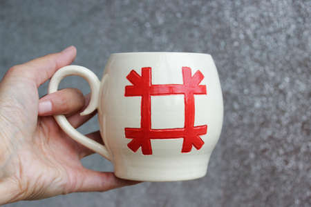 handmade ceramic bowl. clay covered with glaze and passed two firing. ancient Slavic sign Healer.の写真素材