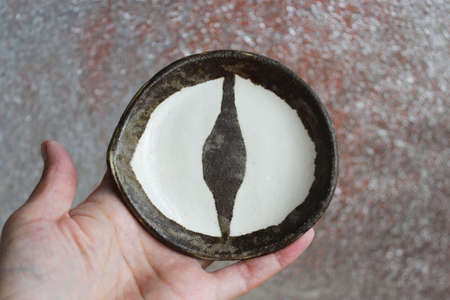 ceramic plate Dragons Eye. Technique of Nerikomi and Neryage. Two types of clay of different color, transparent glaze and two firingの写真素材