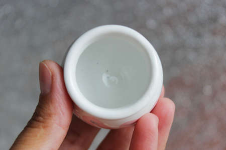 small handmade white clay pot for making wishes or flowers from boutonnieres. Decor engobe, covered with transparent glaze, two firing.の写真素材