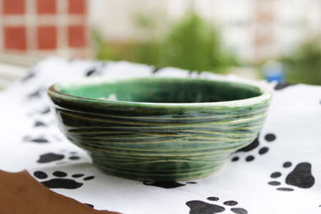 handmade green ceramic plate. made on a potter's wheel, covered with spectacular glaze, passed two firing.の写真素材