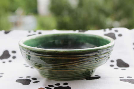 handmade green ceramic plate. made on a potter's wheel, covered with spectacular glaze, passed two firing.の写真素材