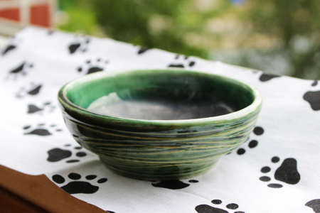 handmade green ceramic plate. made on a potter's wheel, covered with spectacular glaze, passed two firing.の写真素材