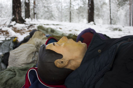 first aid. Dummy of a person on which to train to provide first aid. Reportage from a place in the winter forest where the exercises are taking placeの写真素材
