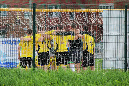 team of soccer players in yellow shirts stands tightly at the gate. soccer game. footballの写真素材