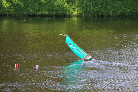 small turquoise sailboat on the lake, controlled remotelyの写真素材
