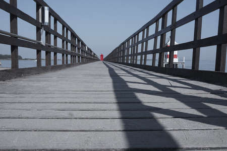 Footbridge with lighthouse in Lignanoの写真素材