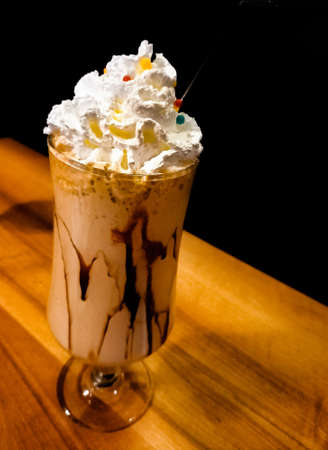 Coffee and milk in a glass with ice cubes on rustic wooden.
Close up of a glass of cappuccino, or espresso with milk and ice in a cup on the table.の写真素材