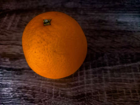 Orange on a wooden table.の写真素材