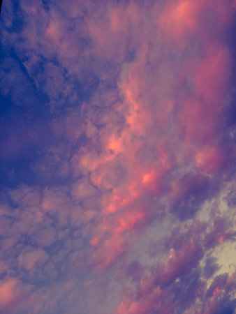 Colorful sunset with pocked clouds. Sky background.の写真素材
