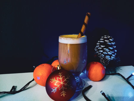 Coffee in a glass on white wooden. Close up of a glass of cappuccino in a cup on the table and christmas decoration.の写真素材