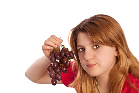 teenager isolated on a white background showing fresh picked grapesの写真素材