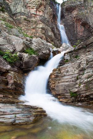 melting glacier water flowwin down the mountain captured with a slow shutter speed