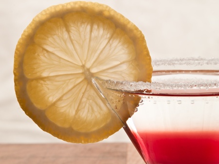 close up of a sugar rim on a martini glass with a lemon wheelの写真素材