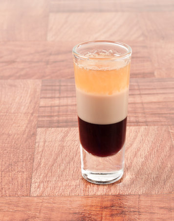 B 52 alcoholic drink layered in a tall shot glass