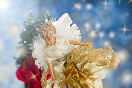 close up of a christmas angel with back lit feathers for wingsの写真素材