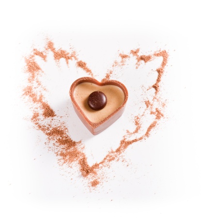 heart shaped chocolates with cocoa dust on a white backgroundの写真素材