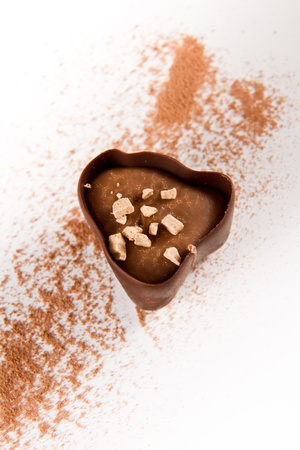 dark chocolate with cocoa powder on a white backgroundの写真素材