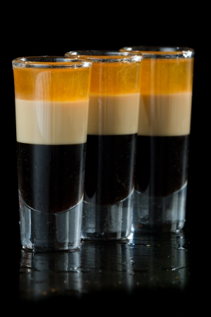 b 52 shots layered and served on a isolated black backgroundの写真素材