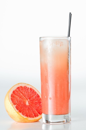 fresh pressed ruby red grape fruit juice isolated on a white backgroundの写真素材