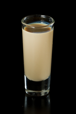 shot of irish cream served isolated on a black backgroundの写真素材
