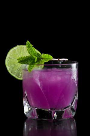 closeup of a  pink  cocktail isolated on a black background served on the rocksの写真素材