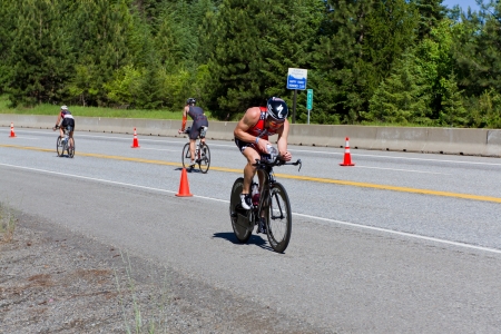 COEUR D ALENE, ID -  JUNE 23: Winner Ben Hoffman, Triathlete on the bike part of the ironman triathlon, June 23 2013 in Coeur d' Alene Idahoのeditorial素材