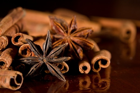 anise stars and cinnamon sticks closeup on a wooden tableの写真素材