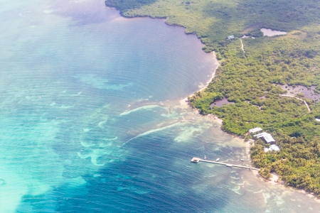 aerial view of the barrier reef of the coast of San Pedro, Belize. with small land masses or cayesの写真素材
