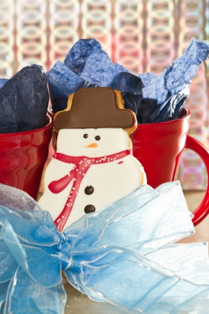 close up of holiday Christmas cookie in the shape of a snow man inside a red coffee cupの写真素材