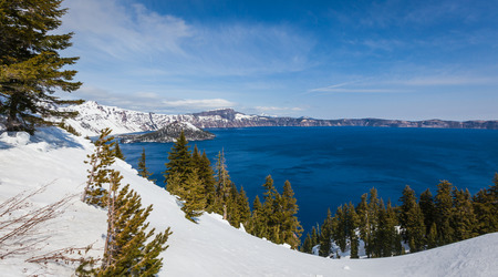 Wizard Island in Crater Lake national park in Oregon early spring with some snow left from winterの写真素材