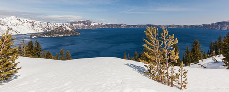 Wizard Island in Crater Lake national park in Oregon early spring with some snow left from winterの写真素材