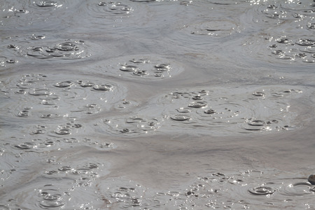 bubbles in the mud in the mud volcano at yellowstone national parkの写真素材