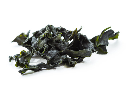 dried seaweed known as pacific wakaame isolated on a white backgroundの写真素材