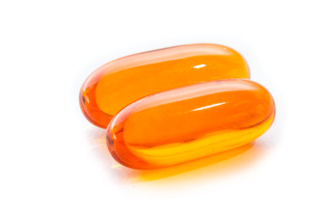 close up of salmon oil capsules isolated on a white background